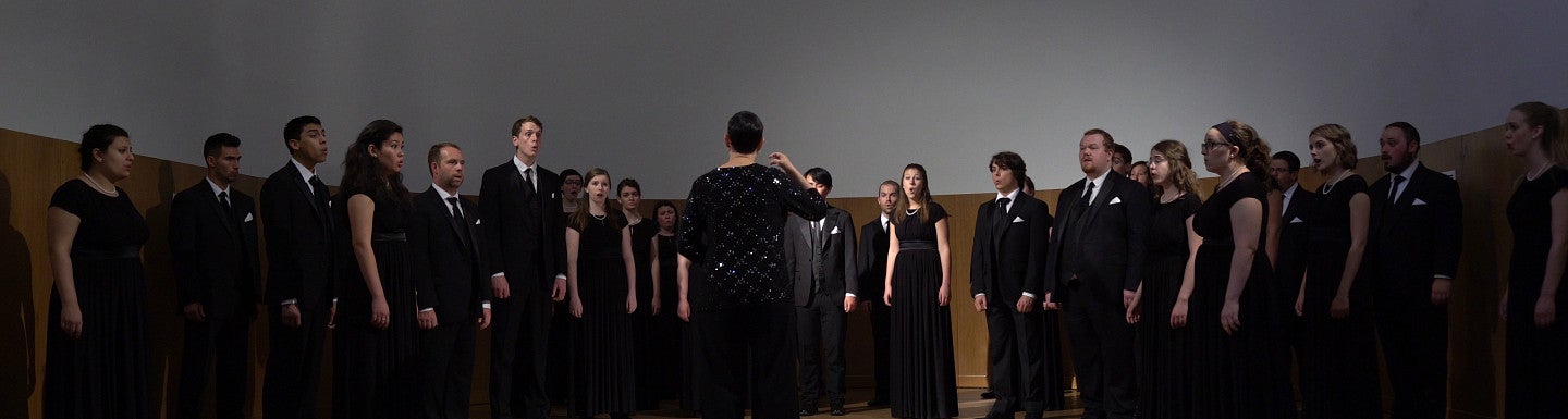 Conductor turned away while choir is performing